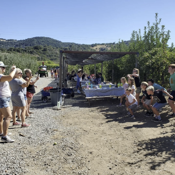 Busy crowd of visitors at the farm entrance during harvest season